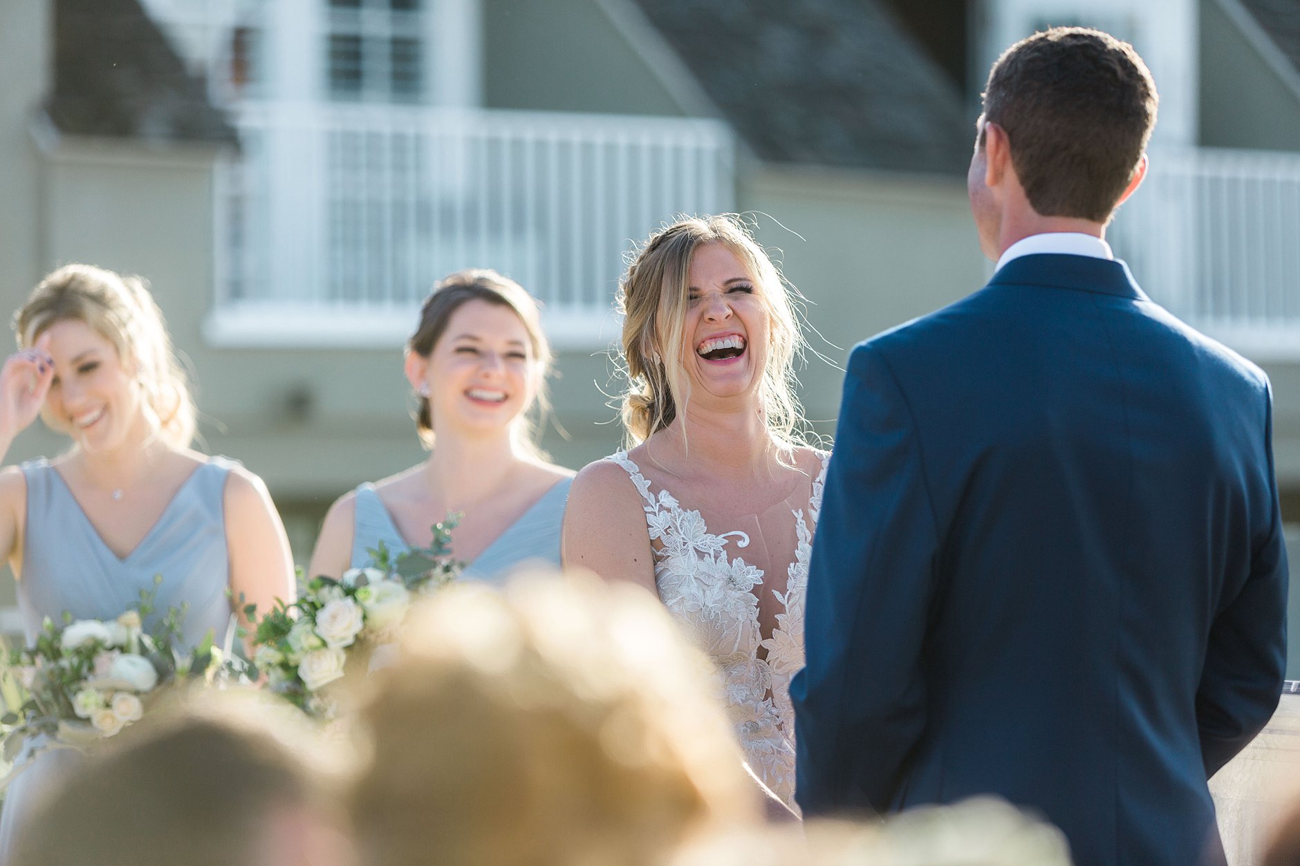 L'Auberge Del Mar Wedding ceremony. Bride laughing hard. Beautiful moment at the ceremony.