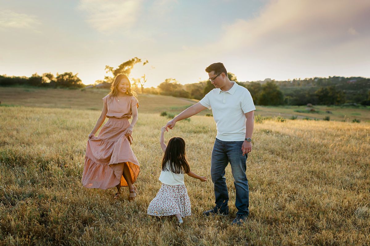 A family dancing in a open field.