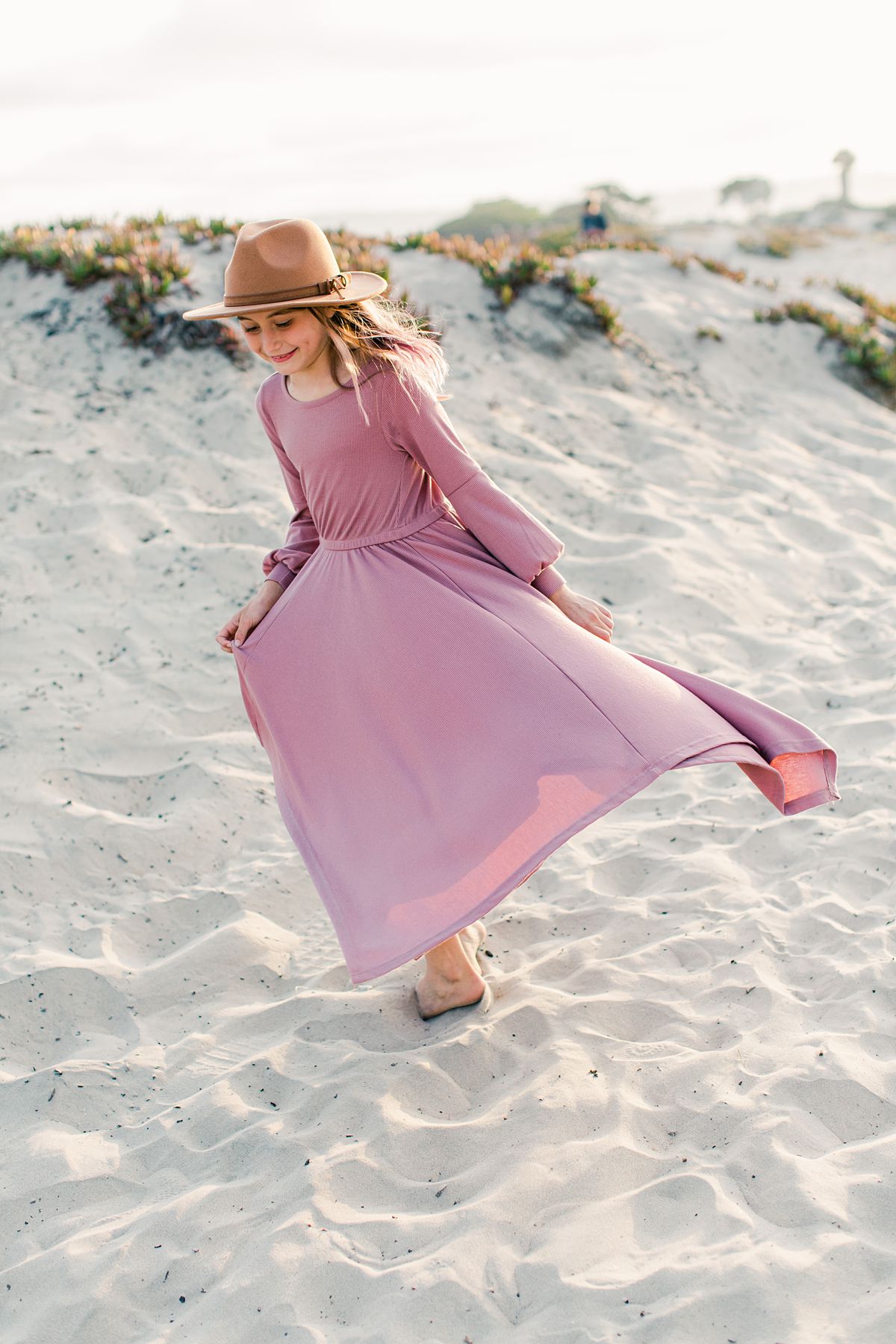 sand dune at Coronado dog beach, a girl in pink dress walking